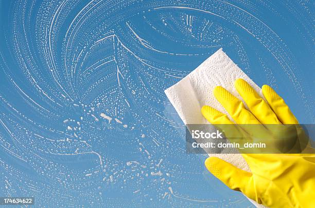 Hand In Yellow Protective Glove Is Cleaning Window Sky Background Stock Photo - Download Image Now