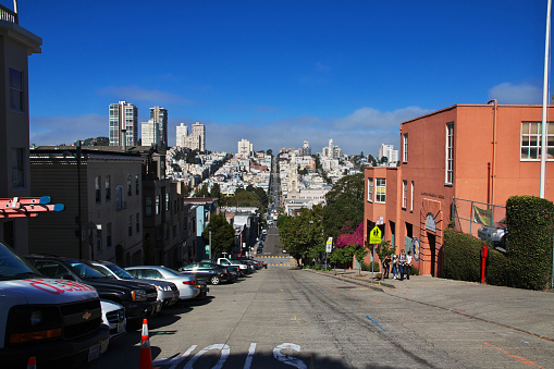 The iconic curves of Lombard Street snaking down Russian Hill to North Beach overlooked by the townhouses and villas of San Francisco, Telegraph Hill, Coit Tower and the islands of the Bay Area beyond. ProPhoto RGB profile for maximum color fidelity and gamut.