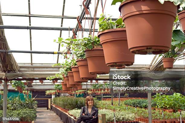 Woman In Greenhouse Stock Photo - Download Image Now - Adult, Adults Only, Agricultural Building