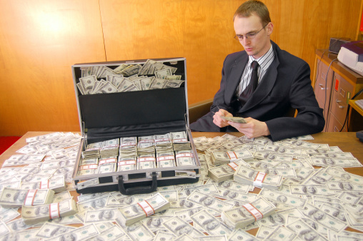 Businessman checks the bailout cash.Similar shots: