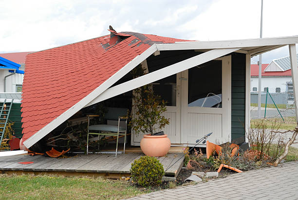 Home with fallen roof and broken pots after a storm stock photo
