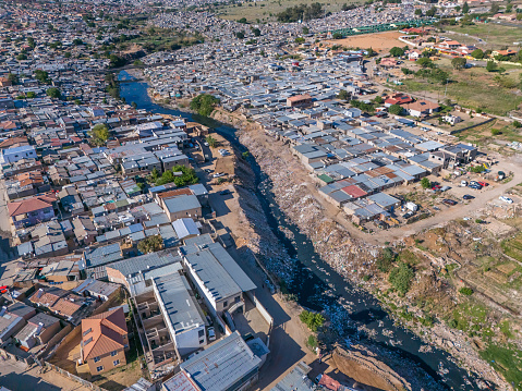 The polluted Jukskei river seen going through the township of Alexandra in Johannesburg and homes fitted with Solar Power for hot water geysers.