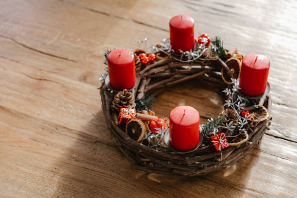 istock Rustic advent wreath with four candles lit every sunday before christmas. Traditional christmas decoration in Switzerland. 1746378546