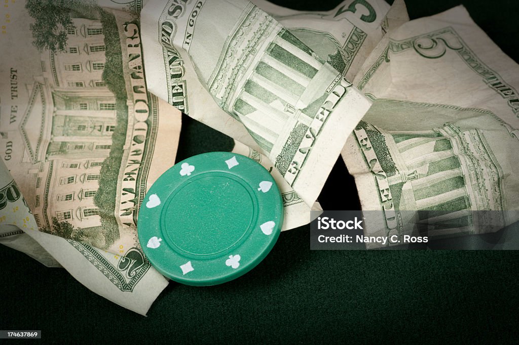 Gaming Chip, Gambling, Money, Losing, Broke A few bucks and one chip are all that are left after a losing night of gambling. Vignetting intentional. Addiction Stock Photo