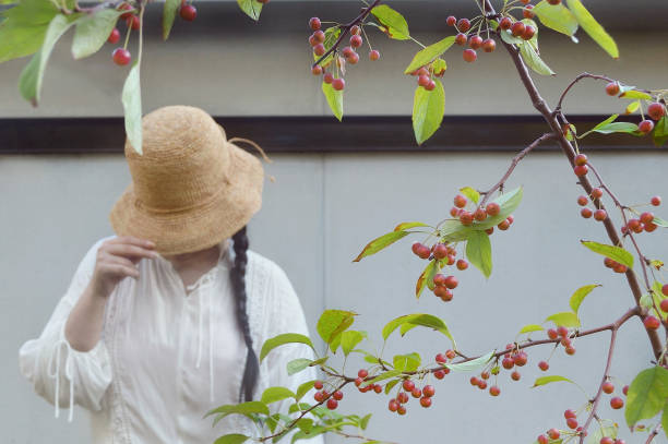 Woman Standitng Behind the Cherry Tree