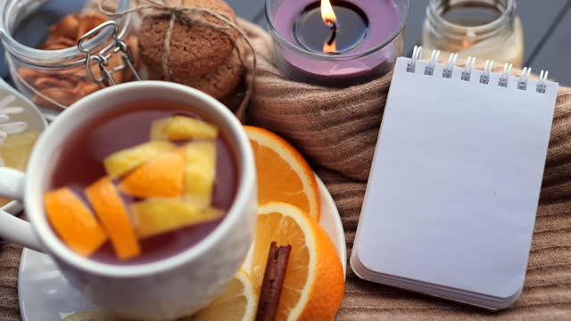Empty notepad lying on the table, cozy home autumn background.