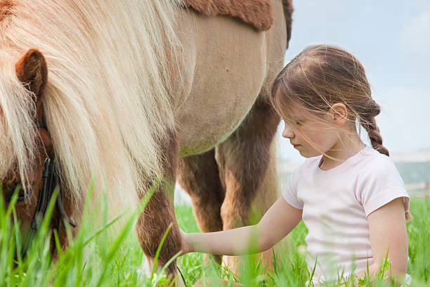 istock little girl and pony 174638706