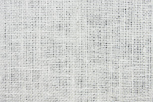 Close-up of a light brown, tightly woven canvas fabric showing uniform texture, ideal for backgrounds and textile projects