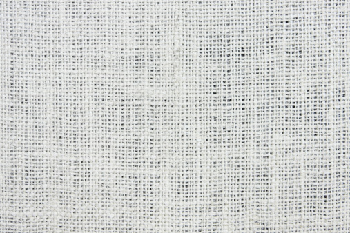 Woven jute fabric textured gauze window treatment material.