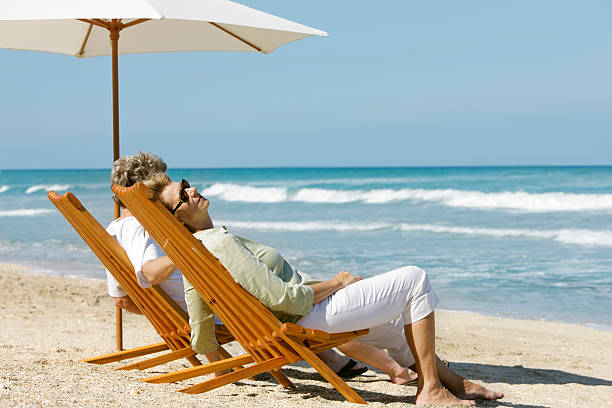 istock retired couple relaxing  in chairs at the beach 174638969