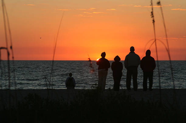 istock Family silhouette against sunset. 174639094