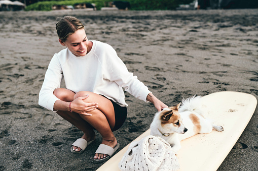 white woman with her dog in the sunrise