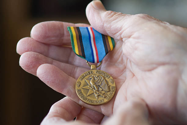 istock Senior hand holding military metal. 174640041