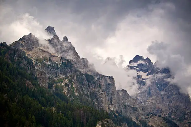Dramatic clouds over the Teton Mountains in Wyoming are visible from Inspiration Point in Grand Tetons National Park.