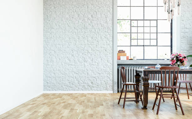 istock Side view of an empty retro interior - a retro, but classic dining room with a gray and white brick wall background, a full simple dining table with chairs and an industrial retro-style window 1746403138