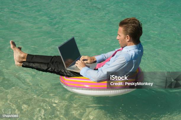 Relaxed Businessman Keeping Afloat On Tropical Sea With Laptop Stock Photo - Download Image Now