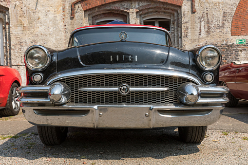 Stade, Germany – July 9, 2023: A Vintage Buick Century from 1955 exhibited at Summertime Drive US Car meeting. Low angle front view.