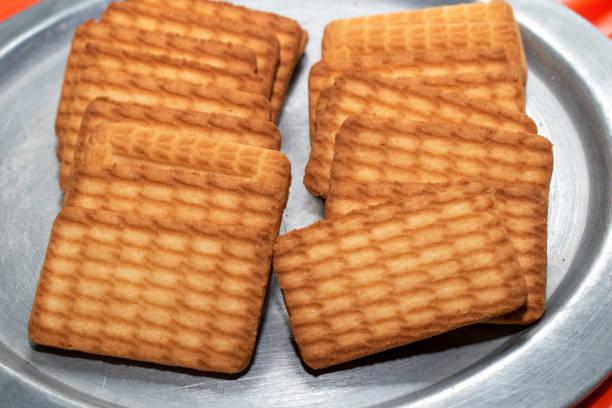 istock Brown Wheat biscuits in the steel plate with blury background. Tea Biscuit morning breakfast 1746426353