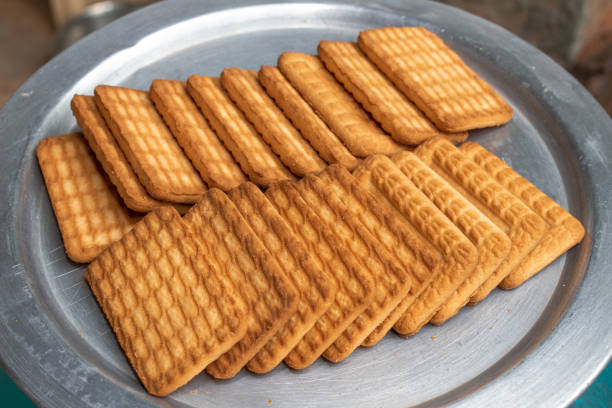 istock Brown Wheat biscuits in the steel plate with blury background. Tea Biscuit morning breakfast 1746426378