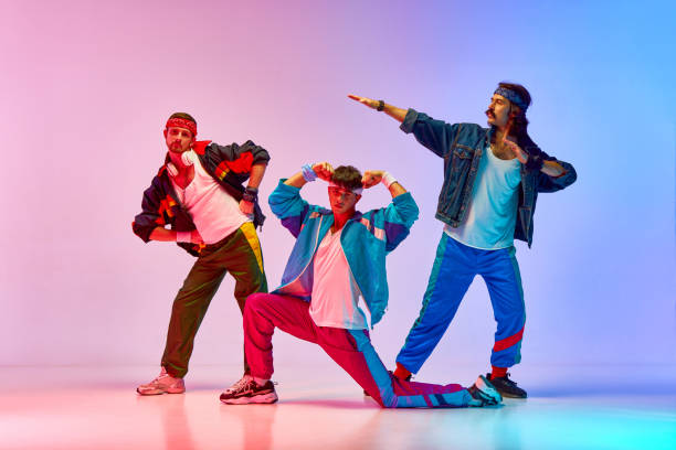 istock Stylish, handsome three men on old style sportswear training against gradient pink blue background in neon light 1746441082