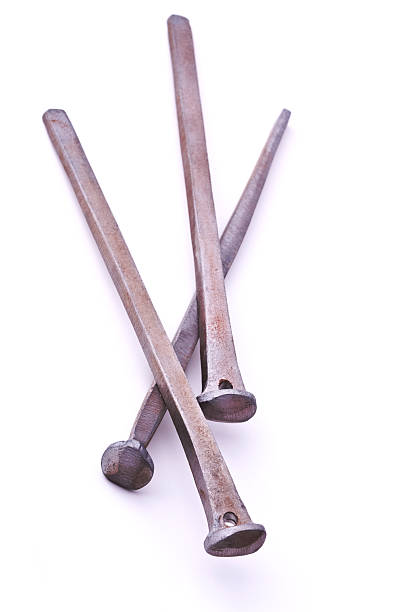 Small nails and carpenter hammer on a wooden worktable. Handmade master. Small carpentry work in the workshop. Home renovation