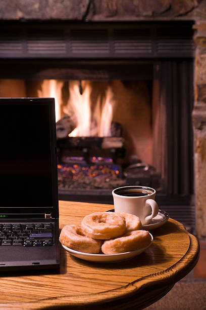 istock Fireplace Laptop Coffee and Donuts 174645616
