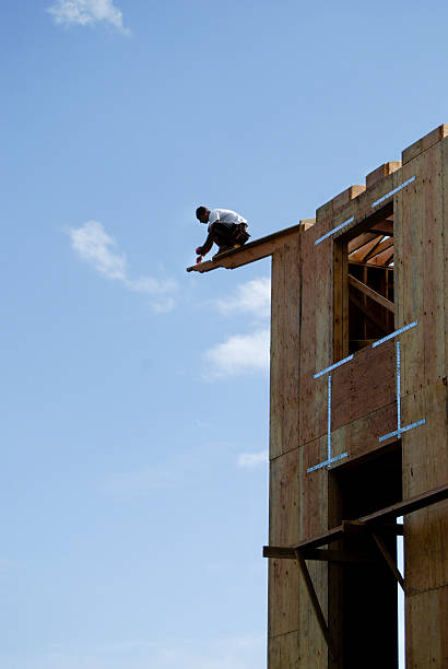 istock Construction worker on the edge of the top of a building 174645737