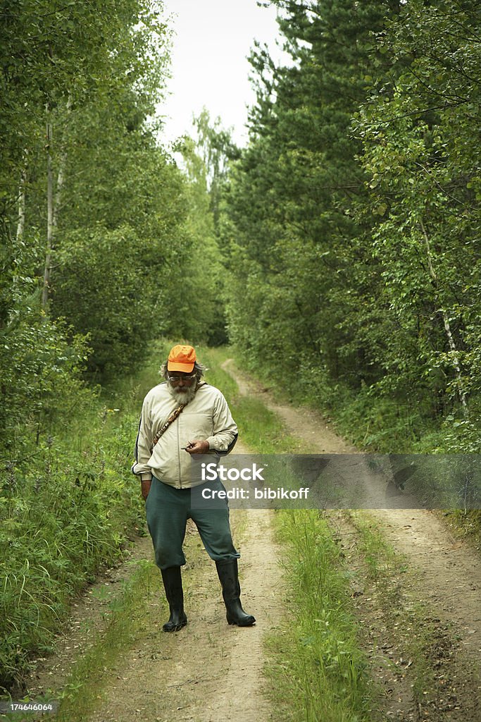 Forester senior forester checking his compass on a dirt road 60-69 Years Stock Photo