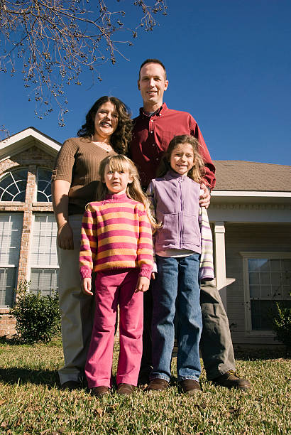 istock Family standing in front of house 174646738