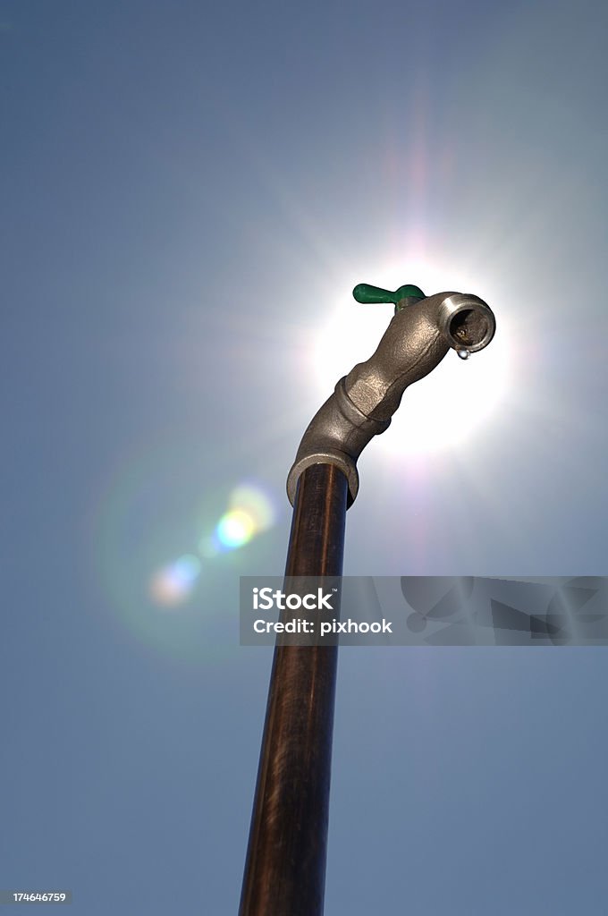 Precious Water "Brass Water Faucet, Stand Pipe and Sunny Blue Sky." Low Angle View Stock Photo