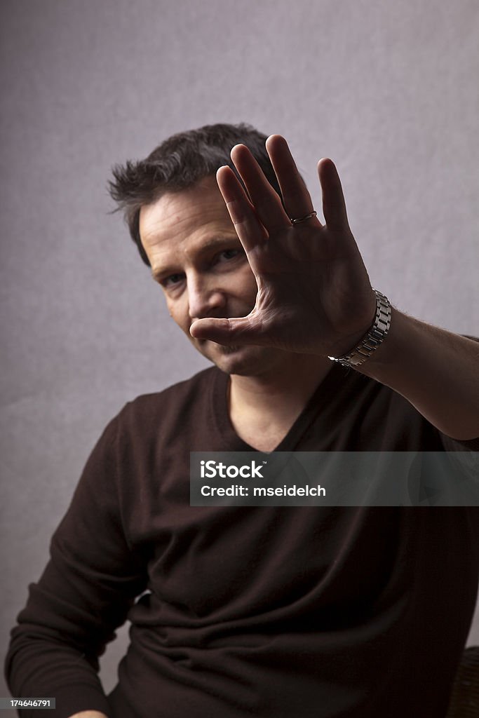 Portrait of a young man - shielding face with hand  35-39 Years Stock Photo