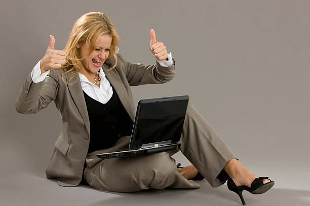 Businesswoman with a laptop  and two thumbs up
