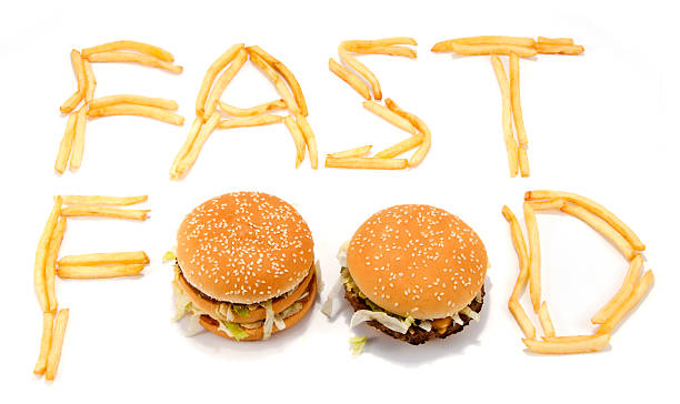 Fast food spelled with French fries and hamburgers stock photo