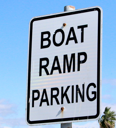 a posted sign indicating boat ramp parking