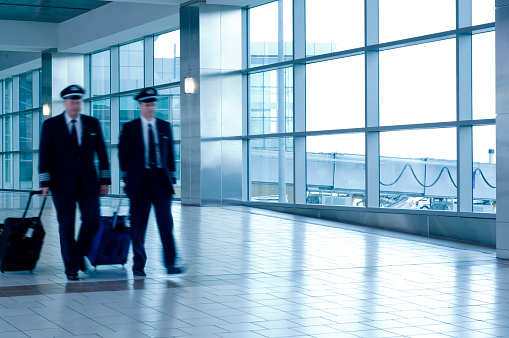 Air travel Pilots walking to gate with copy-space and cool color balance.