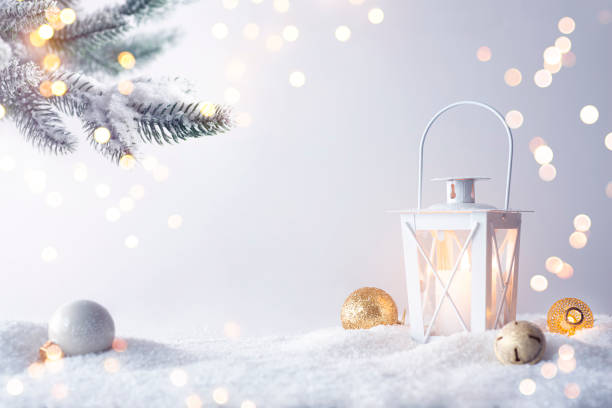Christmas decoration background with lantern in snow and fir tree branch stock photo