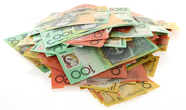 Stack of banknotes isolated on white background Australian money in a messy pile on white australian dollar stock pictures, royalty-free photos & images