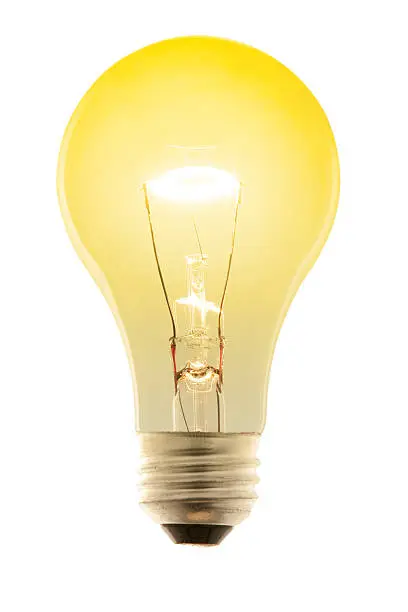 "A glowing yellow incandescent light bulb, isolated on white with clipping path"