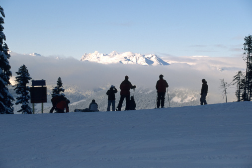 Skiers look over some mountains in Whistler.