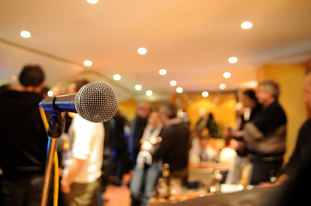 istock microphone on stage with people at concert 174648561