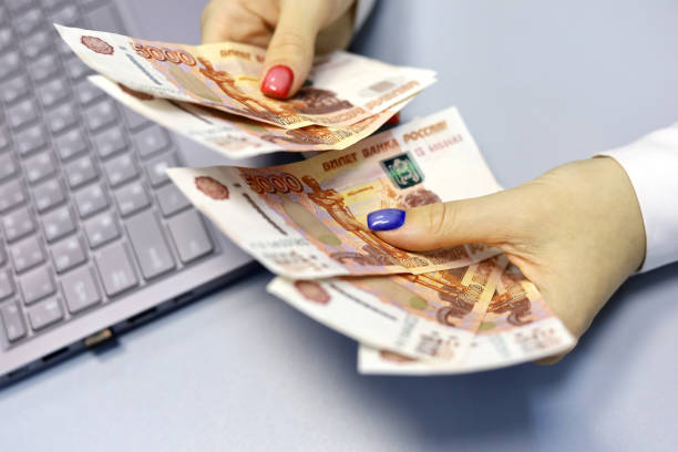 Russian rubles in female hands, cash pay, salary, inflation or savings concept stock photo