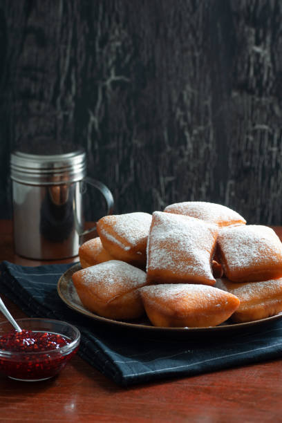 istock New Orleans Style Beignets, Fried Dough Fritters Topped with Powdered Sugar and Raspberry Sauce 1746489371
