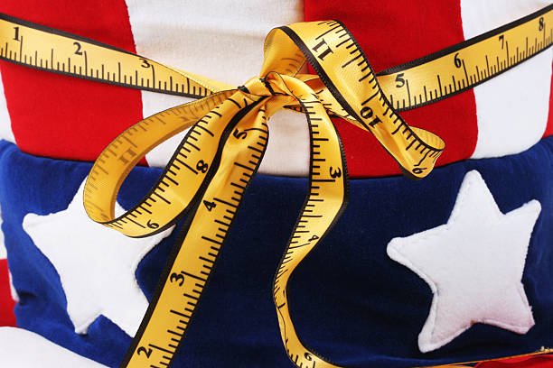 Usa and mesuring tape Concept with a part of Uncle Sam Hat and mesuring tape. uncle sam broke stock pictures, royalty-free photos & images