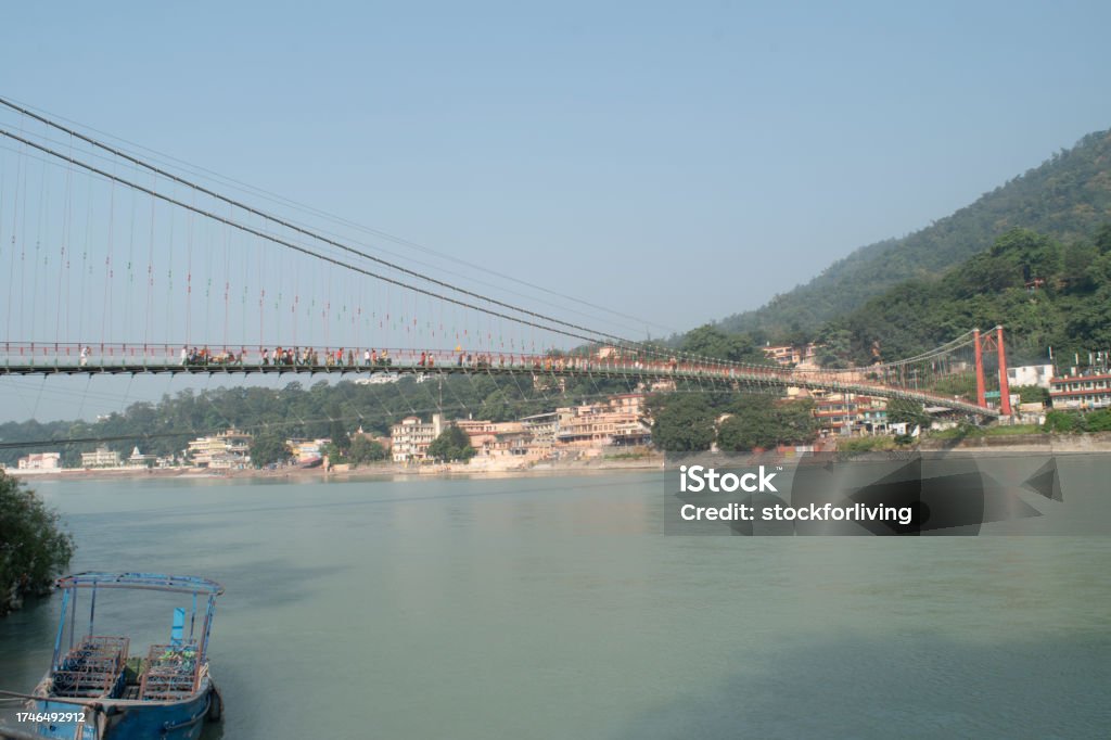 Ram jhula bridge view with holy ganga and mountain at rishikesh Asia Stock Photo