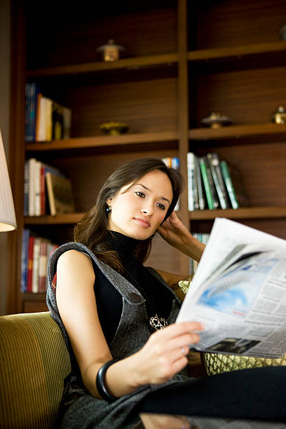 istock Woman reading newspaper 174649489