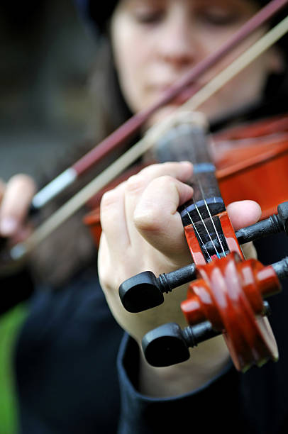 istock the woman is playing violin 174649593