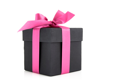 Pink gift box with ribbon on white background