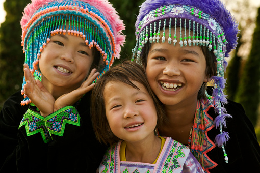 Three Hmong hill tribe girls traditionall dressed.