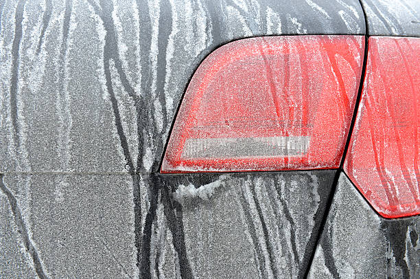 Road Salt Stains on car, winter driving stock photo