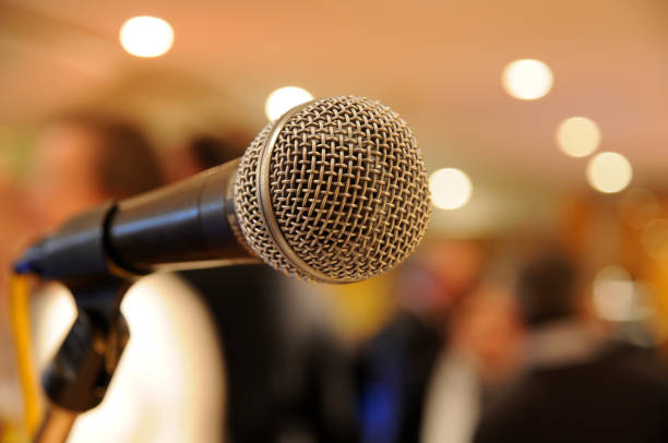 istock microphone on stage with people at concert 174650161